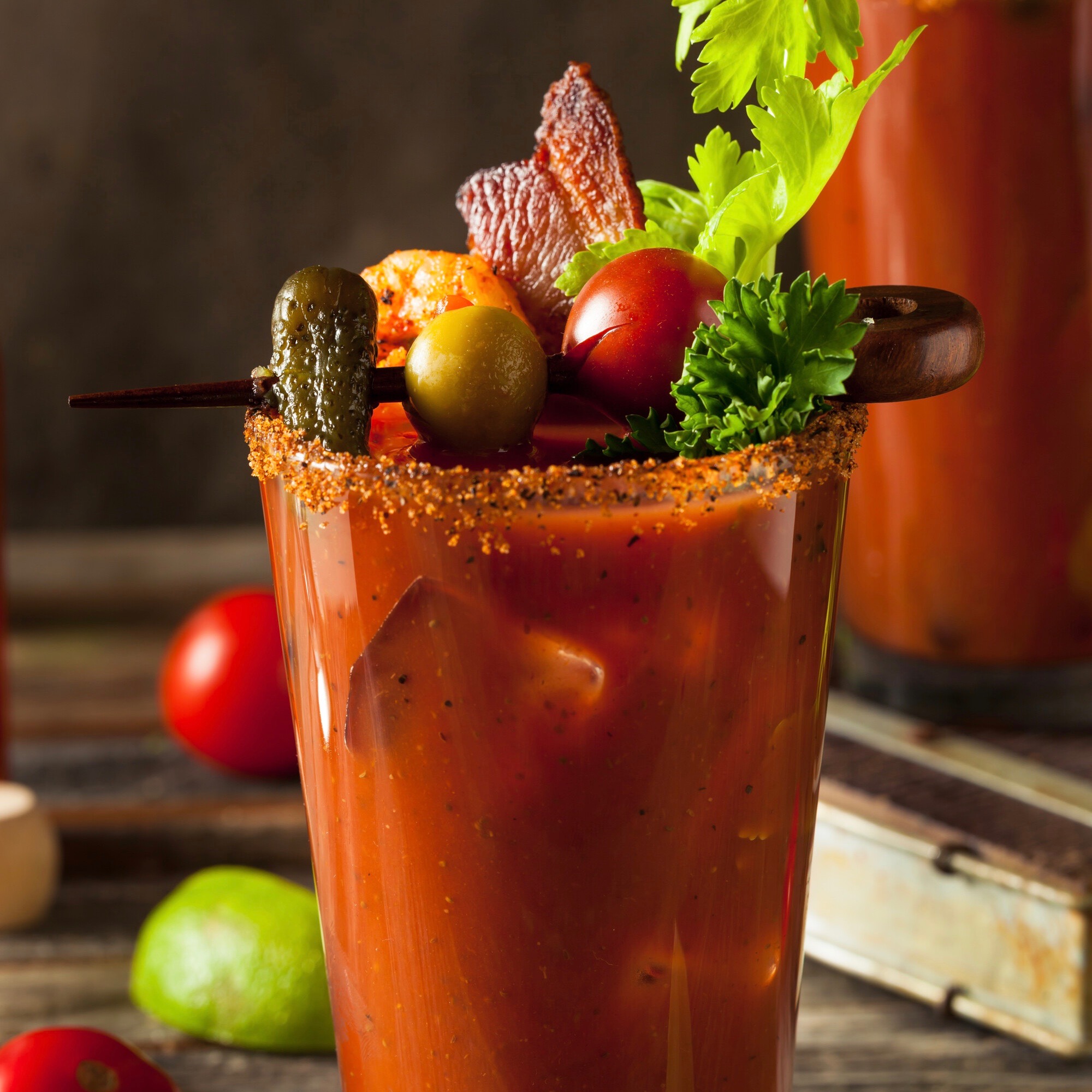 Bloody Mary in a glass with bacon, olives, garnishes