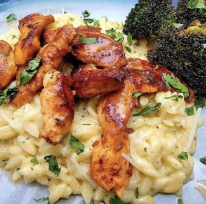 Photo Cajun Blackened Chicken served over creamed rice with broccoli 